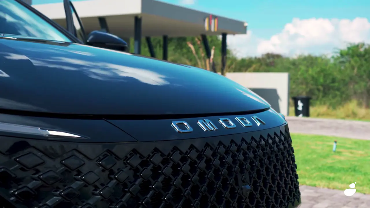 Close-up of the Omoda badge and diamond-pattern grille on the black C5