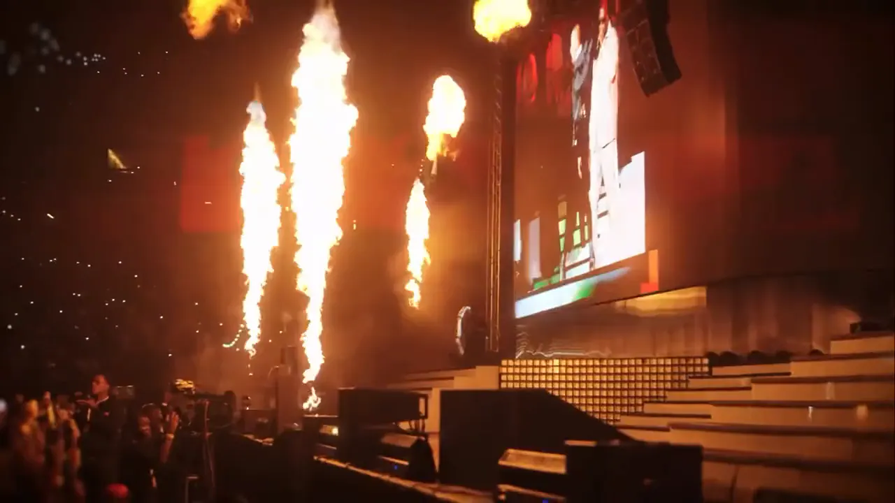 Pyrotechnic flames shooting up beside the stage
