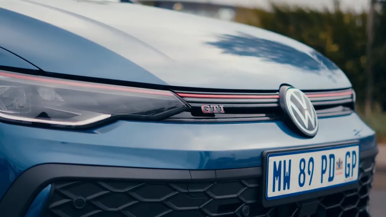 Close-up of the GTI badge and grille on a blue Volkswagen Golf GTI
