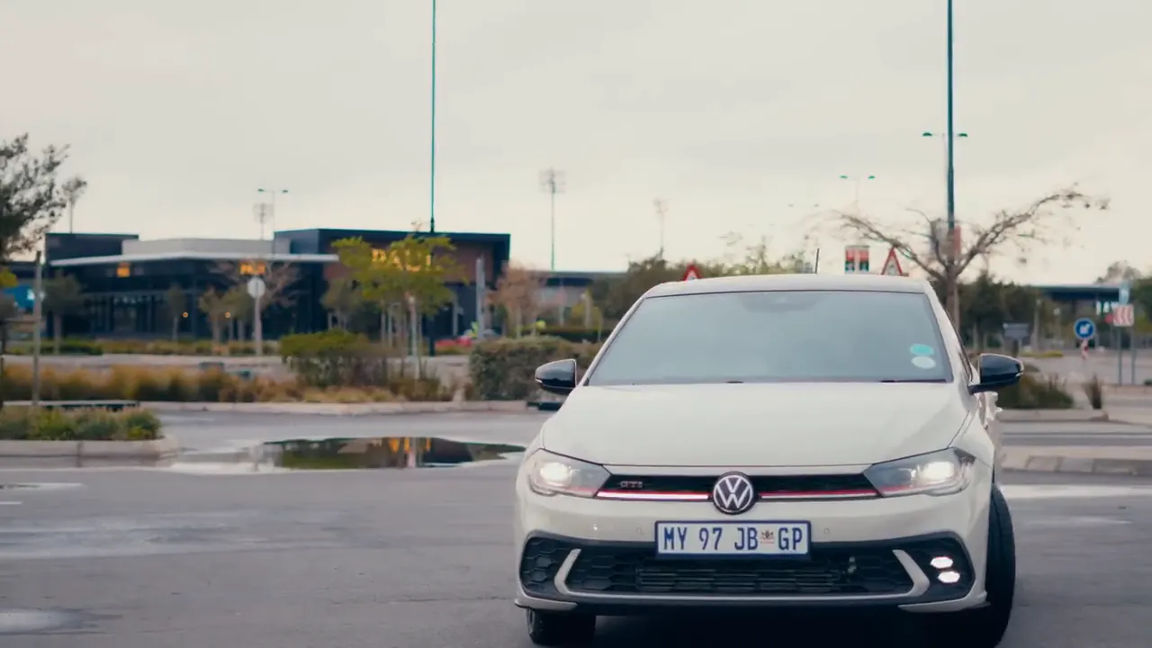 White Volkswagen Polo GTI facing the camera in a shopping-centre car park